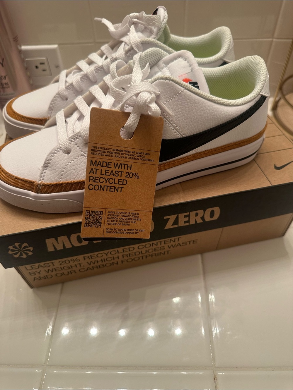 Nike Kids White Sneakers with Brown Accent and Black Swoosh